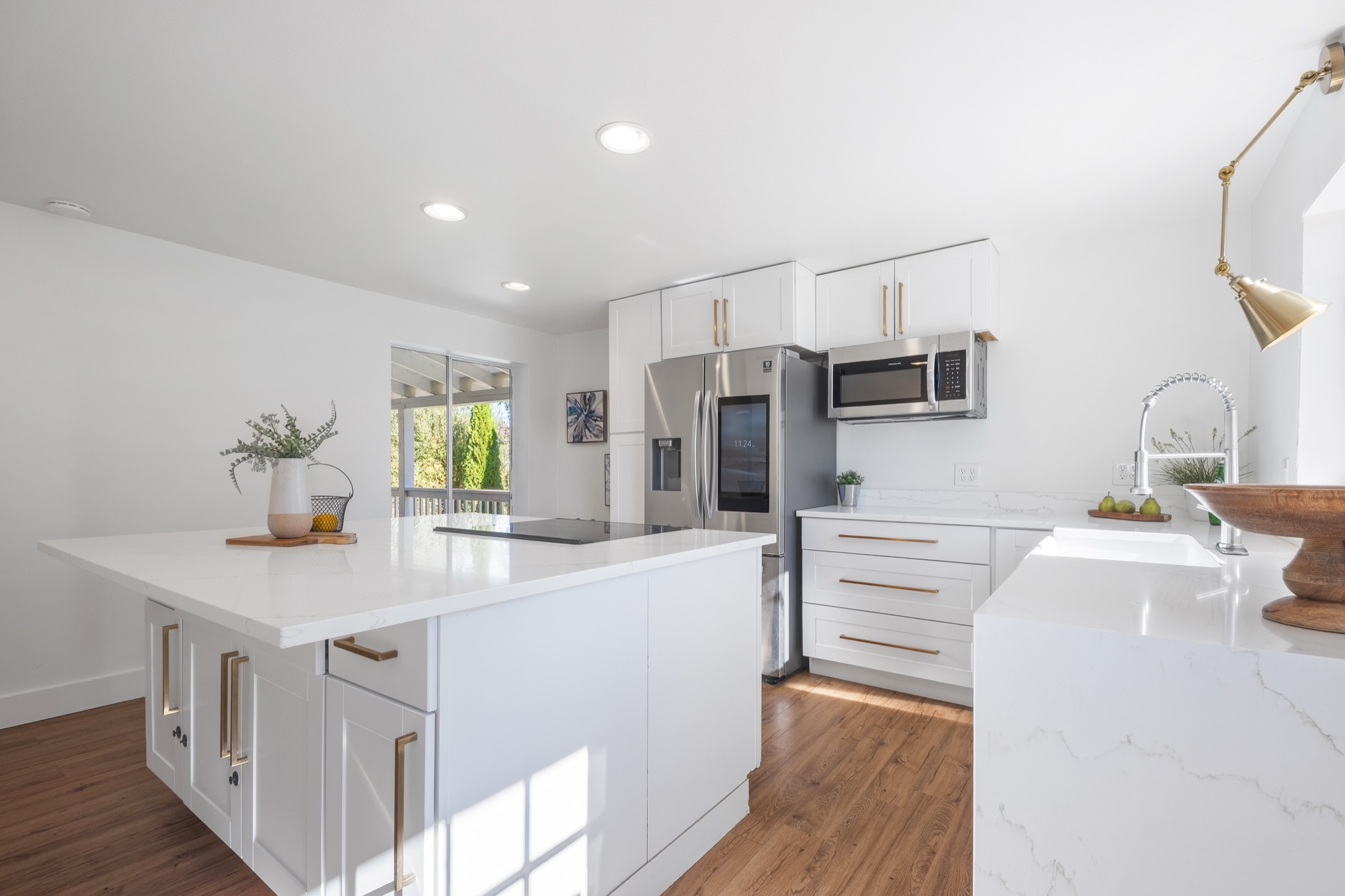 White kitchen with marble island and brushed gold hardware