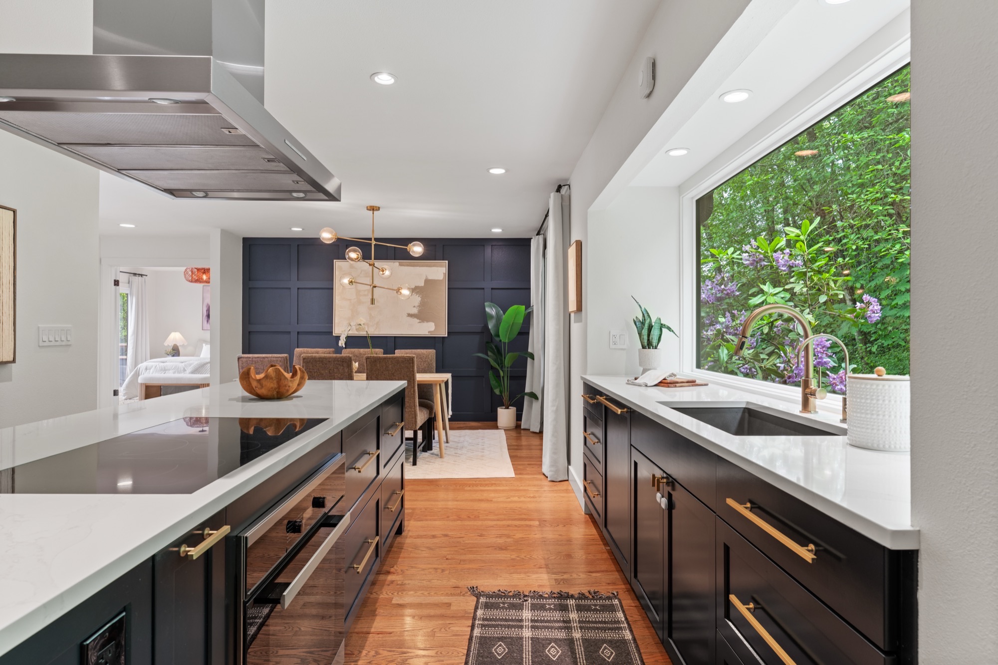 Kitchen and dining room with navy paneled wall